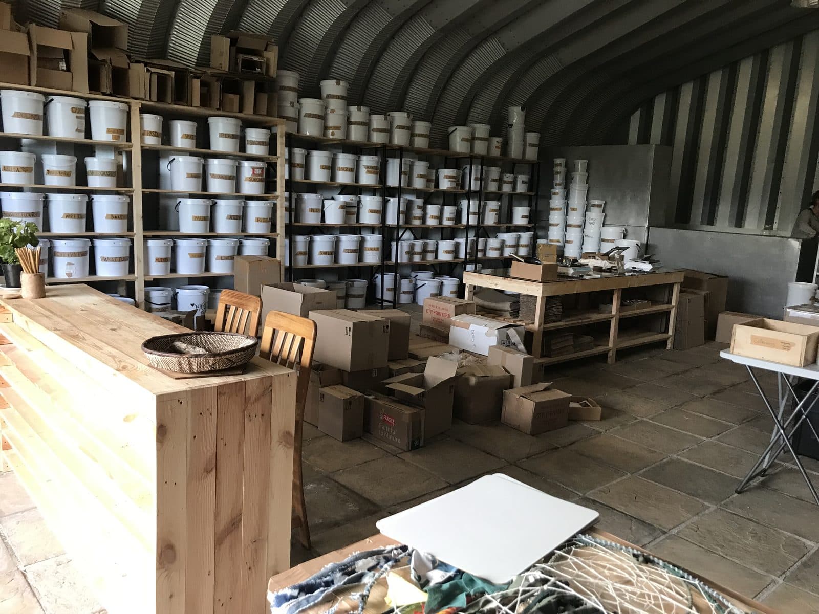 Walls of hand-labelled buckets behind the pine counter at Baskloof.