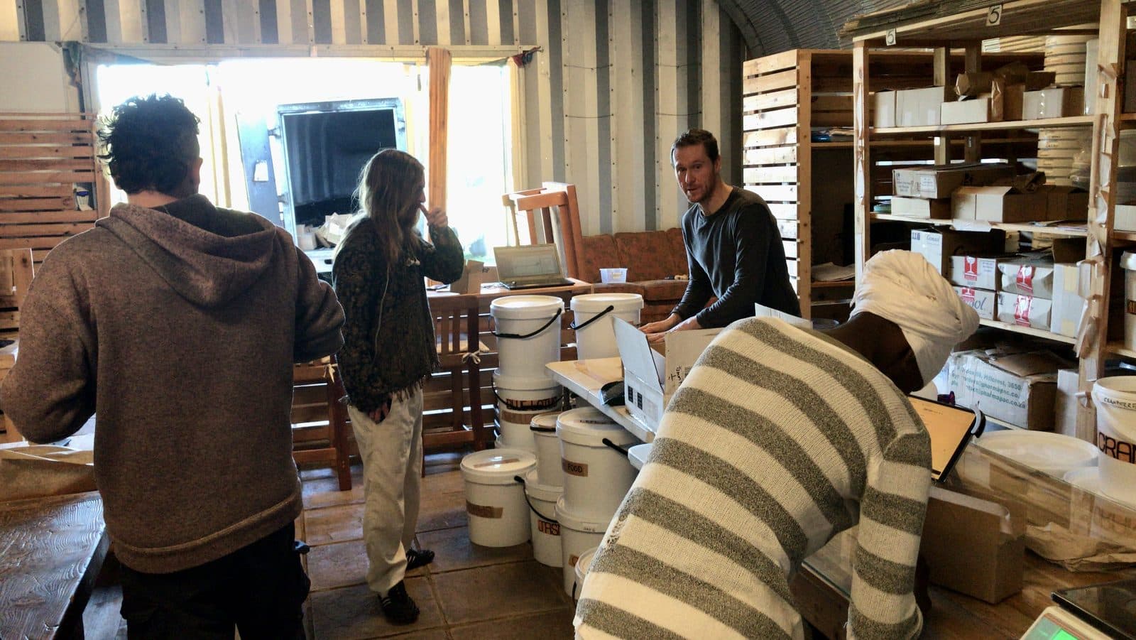 The team packing orders among the labelled buckets.