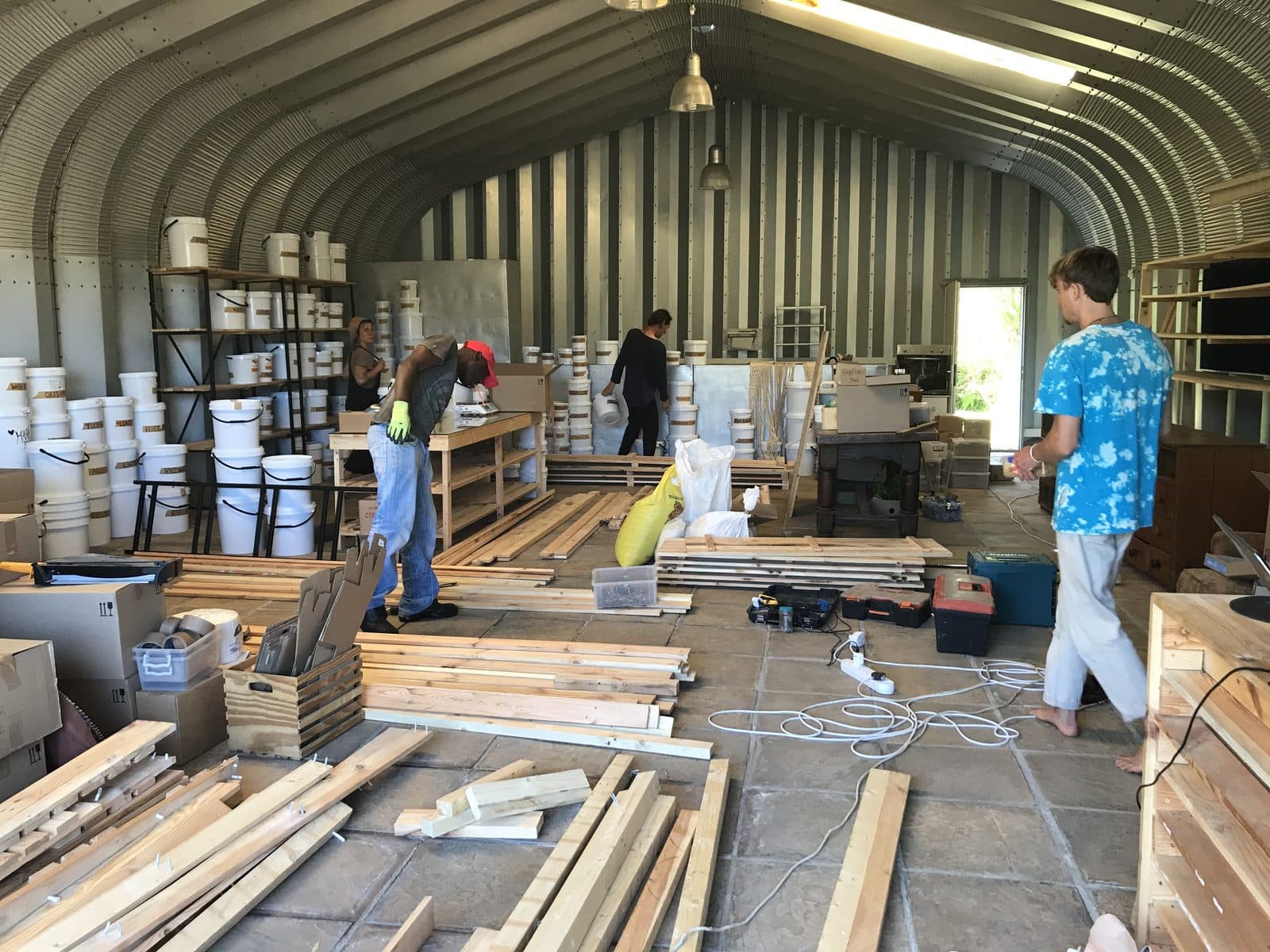 The crew building wooden shelving inside the Baskloof hut.